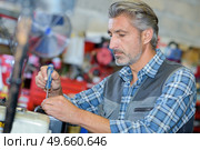 portrait of a small engine mechanic. Стоковое фото, агентство Ingram Publishing / Фотобанк Лори