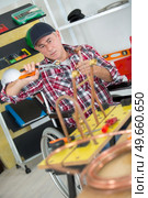 worker plumber using blowtorch for soldering copper fittings. Стоковое фото, агентство Ingram Publishing / Фотобанк Лори