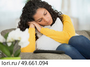 cute woman resting on comfy sofa with sleepy face. Стоковое фото, агентство Ingram Publishing / Фотобанк Лори