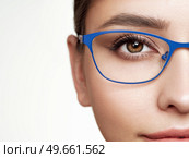 Woman with long eyelashes in eyeglasses. Vision correction. Poor eyesight. Spectacle frame. Makeup, cosmetics, beauty. Close up, macro. Стоковое фото, агентство Ingram Publishing / Фотобанк Лори