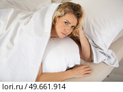 young woman feeling neck pain lying on uncomfortable. Стоковое фото, агентство Ingram Publishing / Фотобанк Лори