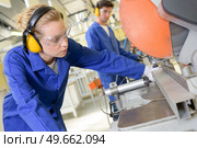 young qualified people forced to work at the factory. Стоковое фото, агентство Ingram Publishing / Фотобанк Лори