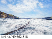 Icelandic glacier with a stream of melting water on a bright day with blue sky. Стоковое фото, агентство Ingram Publishing / Фотобанк Лори
