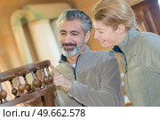 joiner checking the finish of a furniture. Стоковое фото, агентство Ingram Publishing / Фотобанк Лори