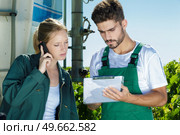 portrait of man and woman holding clipboard next to truck. Стоковое фото, агентство Ingram Publishing / Фотобанк Лори