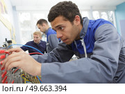 portrait of technician working with cables. Редакционное фото, агентство Ingram Publishing / Фотобанк Лори