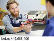 portrait of young engineer fixing propeller of octocopter indoors. Стоковое фото, агентство Ingram Publishing / Фотобанк Лори