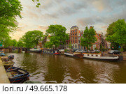 Ancient streets and canals in the city center of Amsterdam. Netherlands. Стоковое фото, агентство Ingram Publishing / Фотобанк Лори
