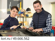 panel beating team in a garage. Стоковое фото, агентство Ingram Publishing / Фотобанк Лори