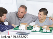 teacher with students next to model. Стоковое фото, агентство Ingram Publishing / Фотобанк Лори