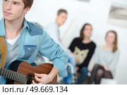 Playing the guitar together. Стоковое фото, агентство Ingram Publishing / Фотобанк Лори