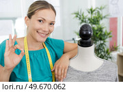 happy young dressmaker showing ok sign. Стоковое фото, агентство Ingram Publishing / Фотобанк Лори