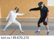 two people and fencing dual. Стоковое фото, агентство Ingram Publishing / Фотобанк Лори