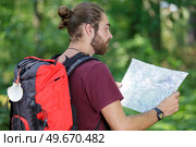 male hiker with backpack looking at map. Стоковое фото, агентство Ingram Publishing / Фотобанк Лори