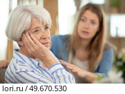upset mother in law and daughter not talking after disagreement. Стоковое фото, агентство Ingram Publishing / Фотобанк Лори