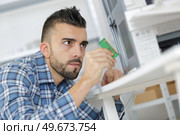man fix mainboard  montage on product. Стоковое фото, агентство Ingram Publishing / Фотобанк Лори