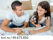 young couple looking the plans of their new purchase. Стоковое фото, агентство Ingram Publishing / Фотобанк Лори
