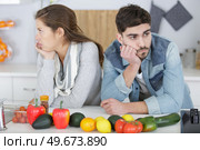 sad couple with hands on head sitting in the kitchen. Стоковое фото, агентство Ingram Publishing / Фотобанк Лори