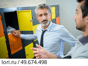 smartly dressed men stood by colourful lockers. Стоковое фото, агентство Ingram Publishing / Фотобанк Лори