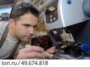 a man fixing a machine. Стоковое фото, агентство Ingram Publishing / Фотобанк Лори