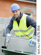 experienced worker working with cement blocks. Стоковое фото, агентство Ingram Publishing / Фотобанк Лори