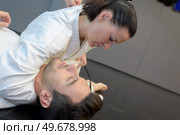 young woman and man judo fighters in sport hall. Стоковое фото, агентство Ingram Publishing / Фотобанк Лори
