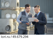 man using phone outside a factory. Стоковое фото, агентство Ingram Publishing / Фотобанк Лори