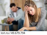 upset woman with drunk husband man in the back. Стоковое фото, агентство Ingram Publishing / Фотобанк Лори