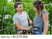 happy couple at climbing park showing climbing carbine for safety. Стоковое фото, агентство Ingram Publishing / Фотобанк Лори