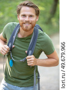 portrait of a young smiling wanderer man with backpack. Стоковое фото, агентство Ingram Publishing / Фотобанк Лори