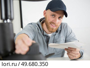 happy man screwing screws into furniture fittings. Стоковое фото, агентство Ingram Publishing / Фотобанк Лори