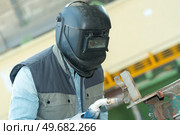 male in face mask welds with argon-arc welding. Стоковое фото, агентство Ingram Publishing / Фотобанк Лори