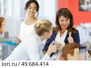 hairdresser apprentice learning to do a hairdo. Стоковое фото, агентство Ingram Publishing / Фотобанк Лори