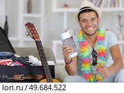 happy man with backpack passport and ticket. Стоковое фото, агентство Ingram Publishing / Фотобанк Лори