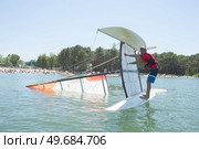 salior trying to right his catamaran after capsize. Стоковое фото, агентство Ingram Publishing / Фотобанк Лори