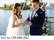 wedding ceremony on a high pier near the river with invited guests. Стоковое фото, агентство Ingram Publishing / Фотобанк Лори