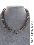 author stylish  beautiful  steel color pearls necklaces with heart pendant demonstrated on maneken. fashion and jewelry concept. Стоковое фото, агентство Ingram Publishing / Фотобанк Лори
