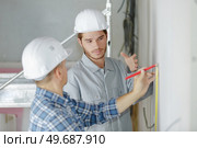 plasterers sealing joint of building wall. Стоковое фото, агентство Ingram Publishing / Фотобанк Лори