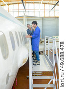 People looking at fuselage of aircraft. Стоковое фото, агентство Ingram Publishing / Фотобанк Лори