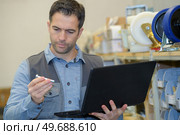 worker inspecting a part of a product. Стоковое фото, агентство Ingram Publishing / Фотобанк Лори
