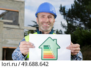 builder with an energy rating sign. Стоковое фото, агентство Ingram Publishing / Фотобанк Лори