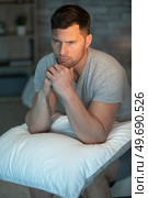 depressed man sitting on his bed and feeling bad. Стоковое фото, агентство Ingram Publishing / Фотобанк Лори
