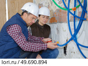 installation new black pe septic tank in construction site. Стоковое фото, агентство Ingram Publishing / Фотобанк Лори