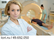 female doctor looking at camera in mri room of hospital. Стоковое фото, агентство Ingram Publishing / Фотобанк Лори