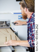 man working on a wood shaper. Стоковое фото, агентство Ingram Publishing / Фотобанк Лори