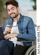 closeup of happy disabled man uses laptop a. Стоковое фото, агентство Ingram Publishing / Фотобанк Лори
