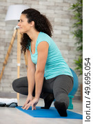 woman stretch her body at home. Стоковое фото, агентство Ingram Publishing / Фотобанк Лори