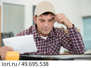 plumber installing water heating radiator. Стоковое фото, агентство Ingram Publishing / Фотобанк Лори