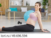 pregnant woman meditating at home. Стоковое фото, агентство Ingram Publishing / Фотобанк Лори