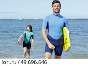 couple of body boarders getting out of the sea. Стоковое фото, агентство Ingram Publishing / Фотобанк Лори
